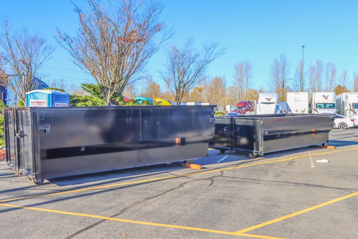 Professional dumpster rental service with roll-off container on residential driveway in Highland Springs